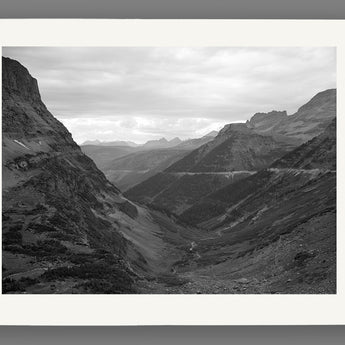 A mockup of a paper print reproduction of a vintage landscape photography of the Rocky Mountains