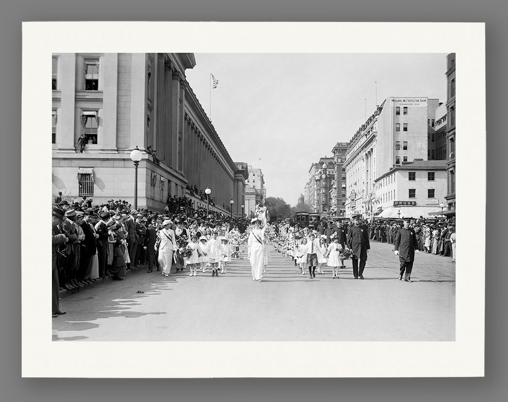 Vintage black and white photo of a street scene with people and buildings.