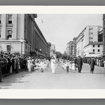 Vintage black and white photo of a street scene with people and buildings.