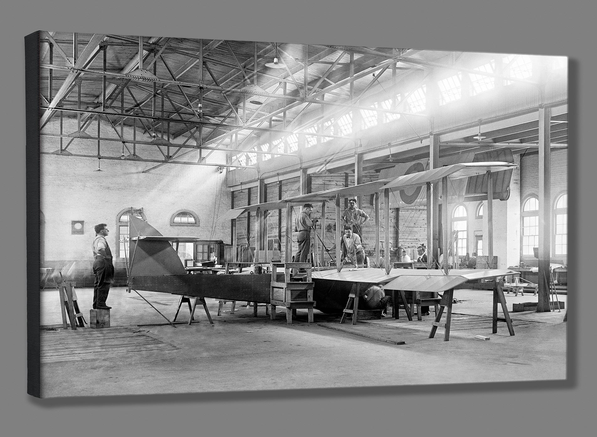 A fine art canvas print of a vintage image of men working in and Alexandria airplane factory