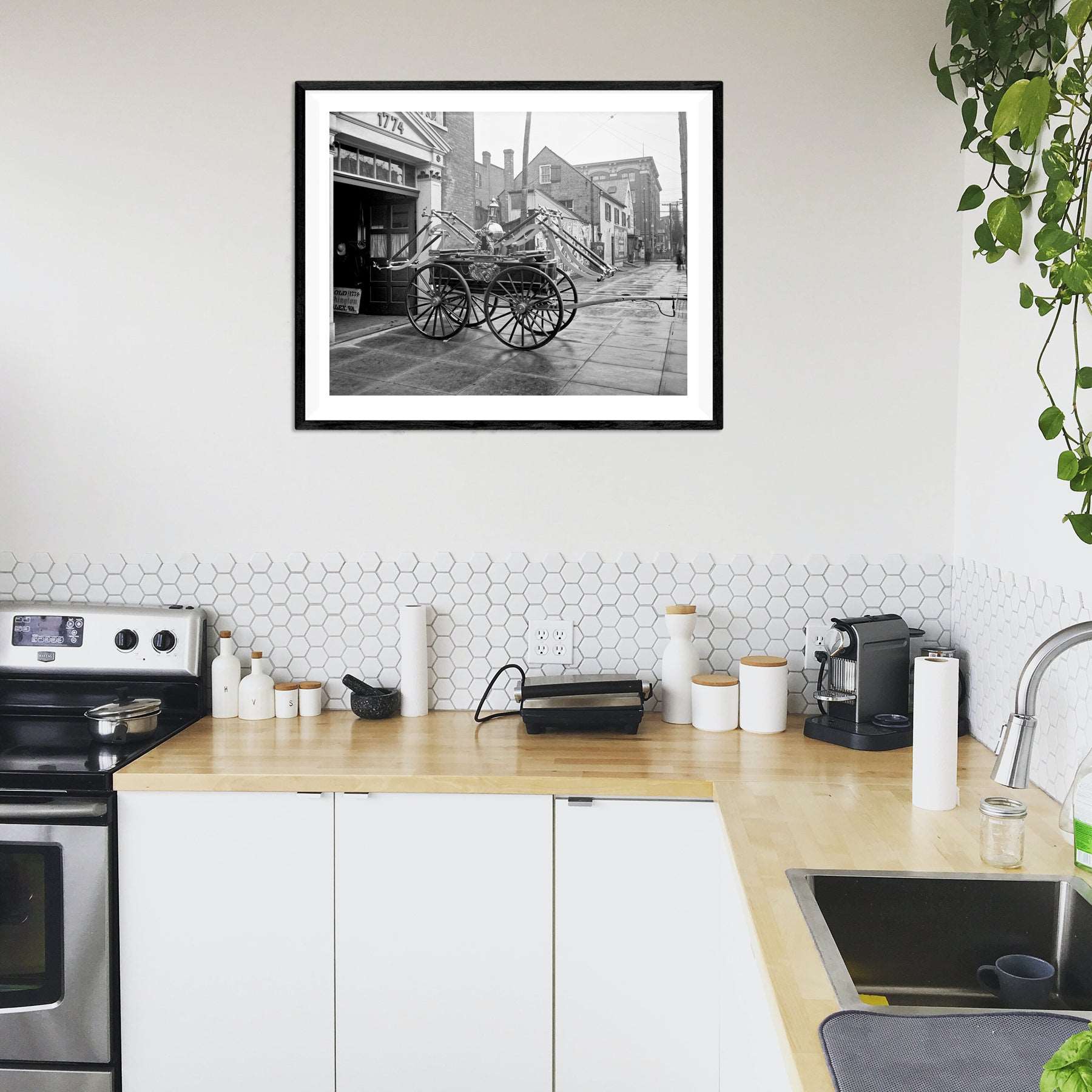 A kitchen with a framed print of a photograph of a vintage fire engine in Alexandria