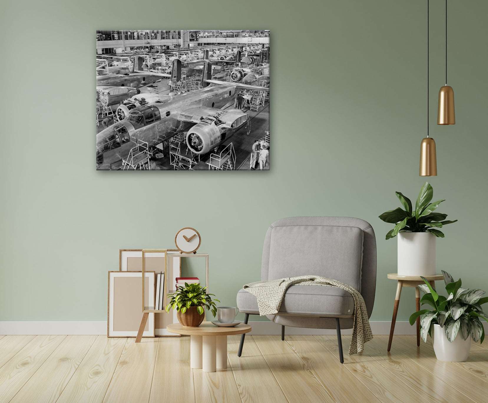 A living room with a green wall and a canvas print of a vintage photograph of planes being assembled