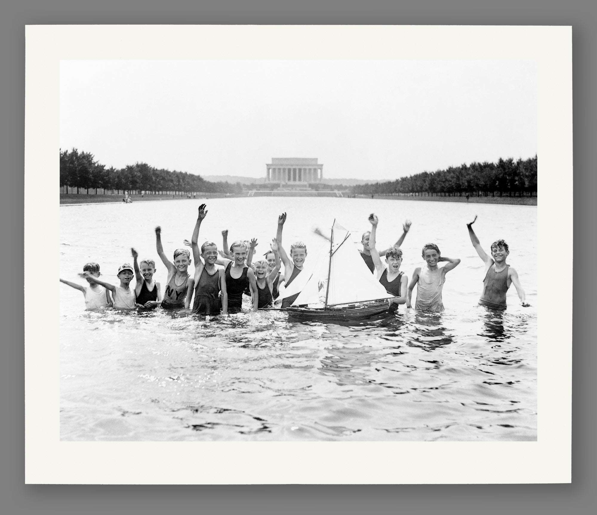 A paper print reproduction of vintage photograph of Washington DC, featuring children playing in the Reflecting Pool