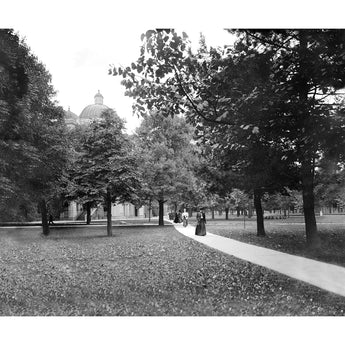 A vintage photograph of several people walking through the University of Michigan's campus