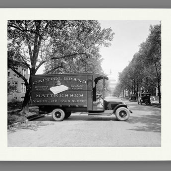 A paper print reproduction of vintage photograph featuring a Capitol Bedding Truck