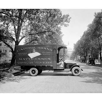 A vintage photograph in black and white, featuring a Capitol Bedding Truck in Washington Dc