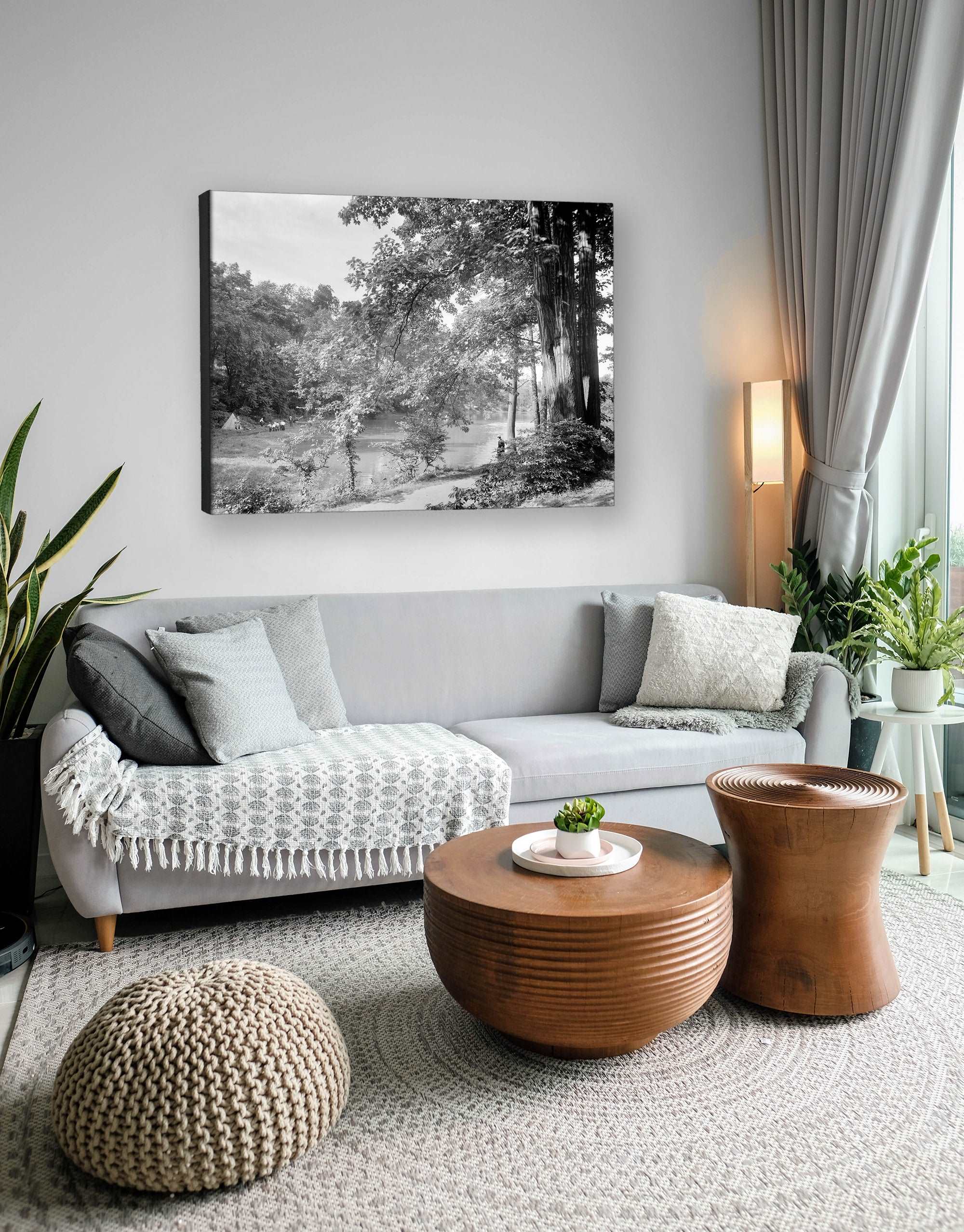 A photo of a living room with a canvas print on the wall, featuring a black and white photo of Fairmount Park