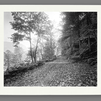 A mockup of a paper print of a black and white photograph of a trail along the Delaware Water Gap
