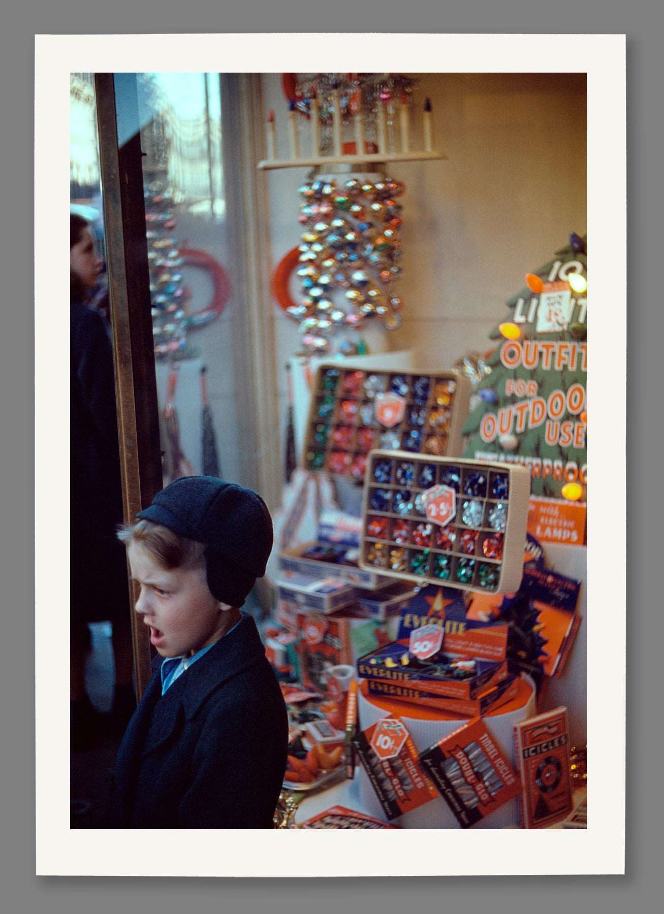 A paper print of a vintage, color image of a Christmas Display in a store window