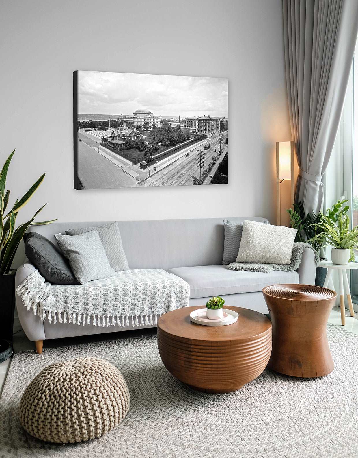 A fine art canvas print hanging on a living room all above a gray couch