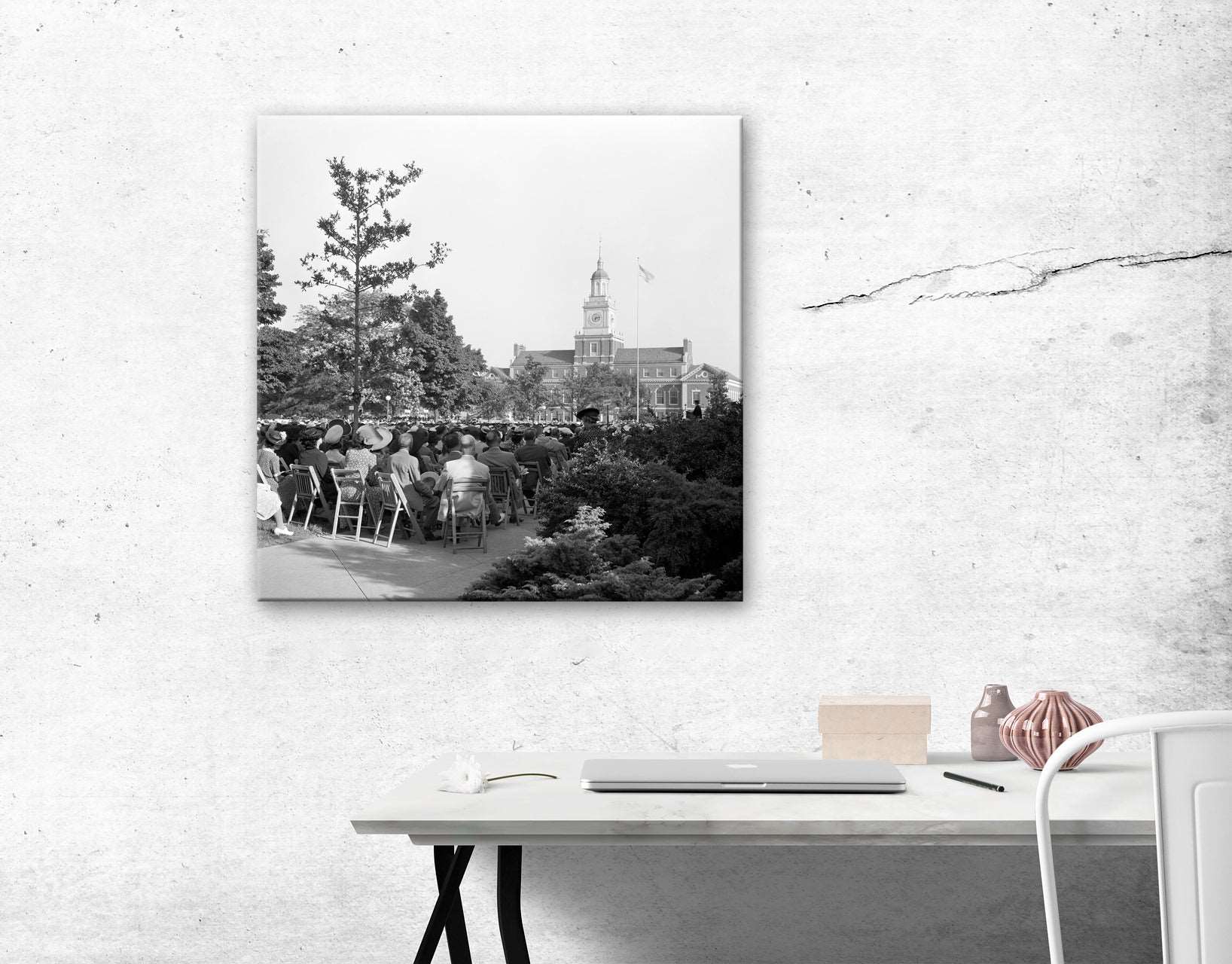 A canvas reproduction print of a vintage photograph of Howard University hanging on a wall above a desk