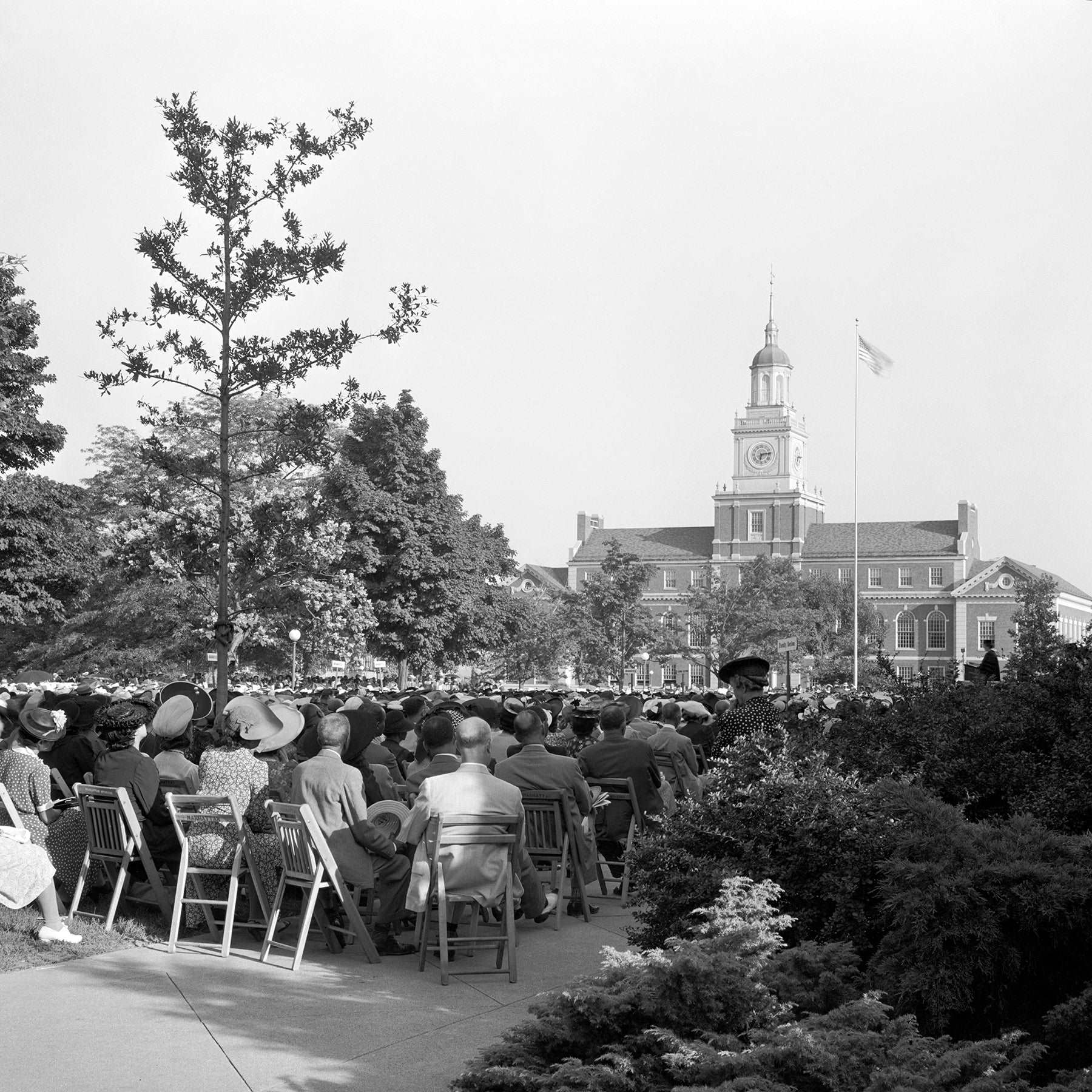 A vintage, black and white photograph of a commencement ceremony at Howard University