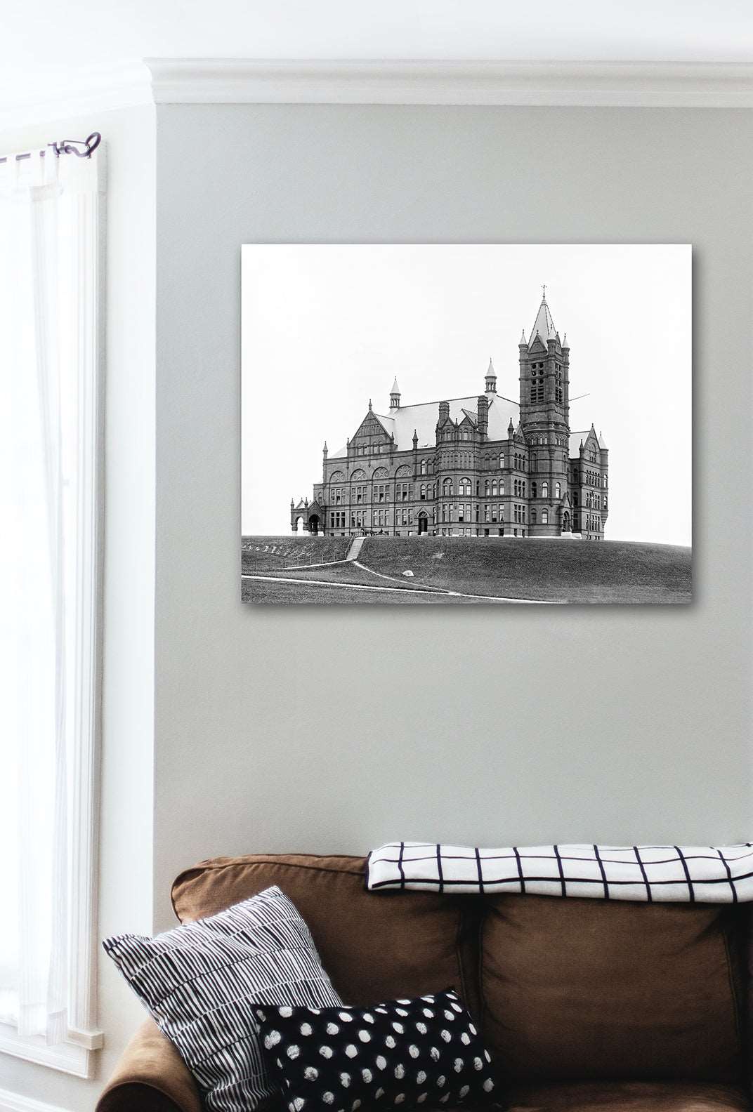 A living room wall with a canvas print of a vintage photograph of Syracuse University