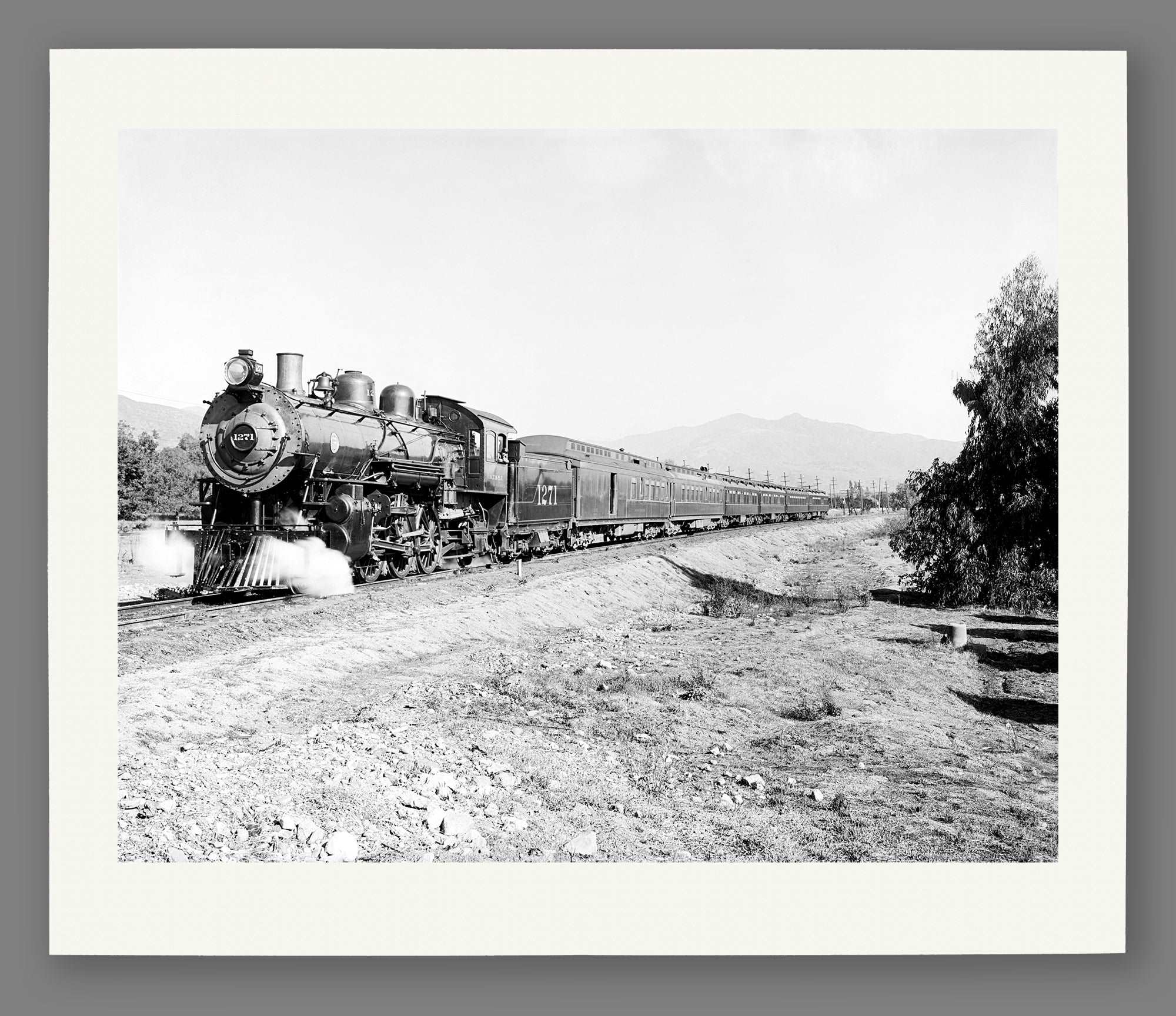 A paper print of vintage photography featuring an Overland Limited Train