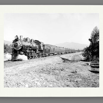 A paper print of vintage photography featuring an Overland Limited Train