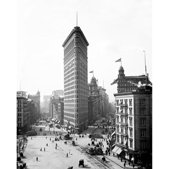 A black and white vintage photograph of the Flatiron Building in New York City