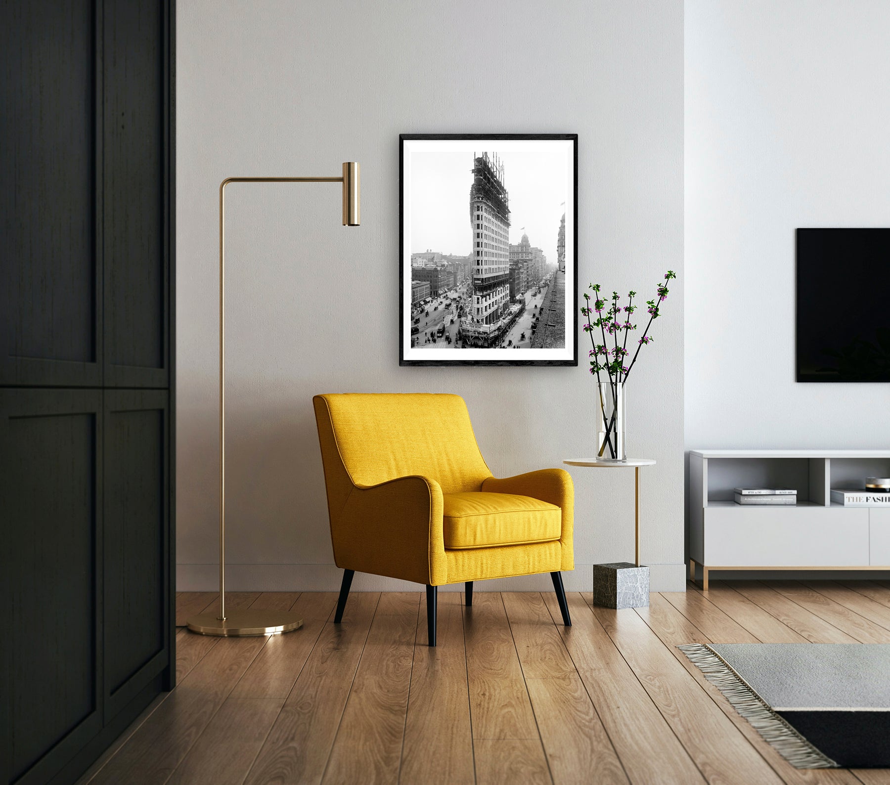 A digitally created rendering of a framed print of a photograph of the Flatiron Building while under construction hanging on a living room wall