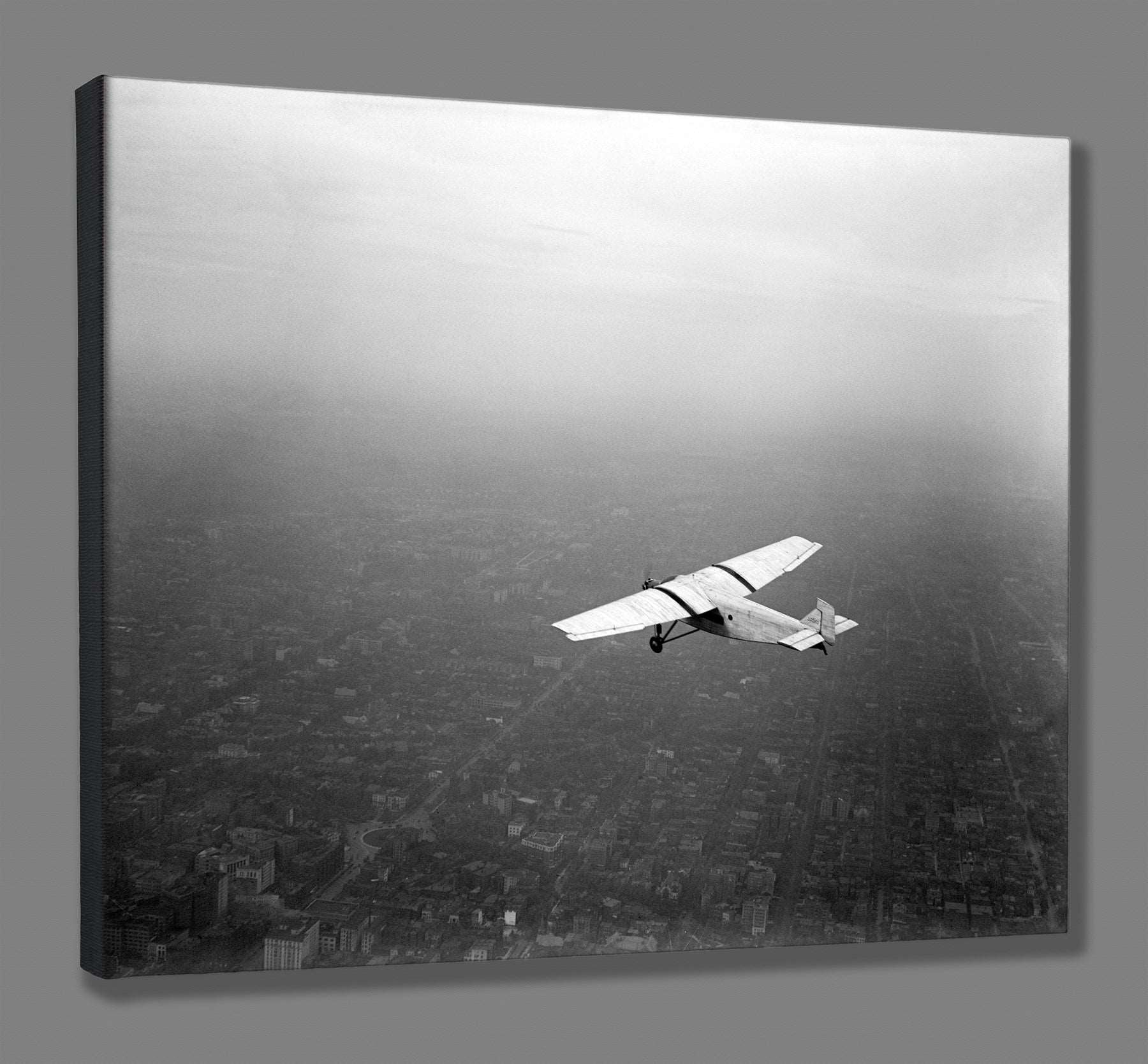 A canvas print reproduction of a vintage photograph of a Ford Motor Co Plane in flight