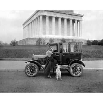 A vintage photograph of a woman and dog in front of a Ford 1 Door Sedan at the Lincoln Memorial in Washington DC