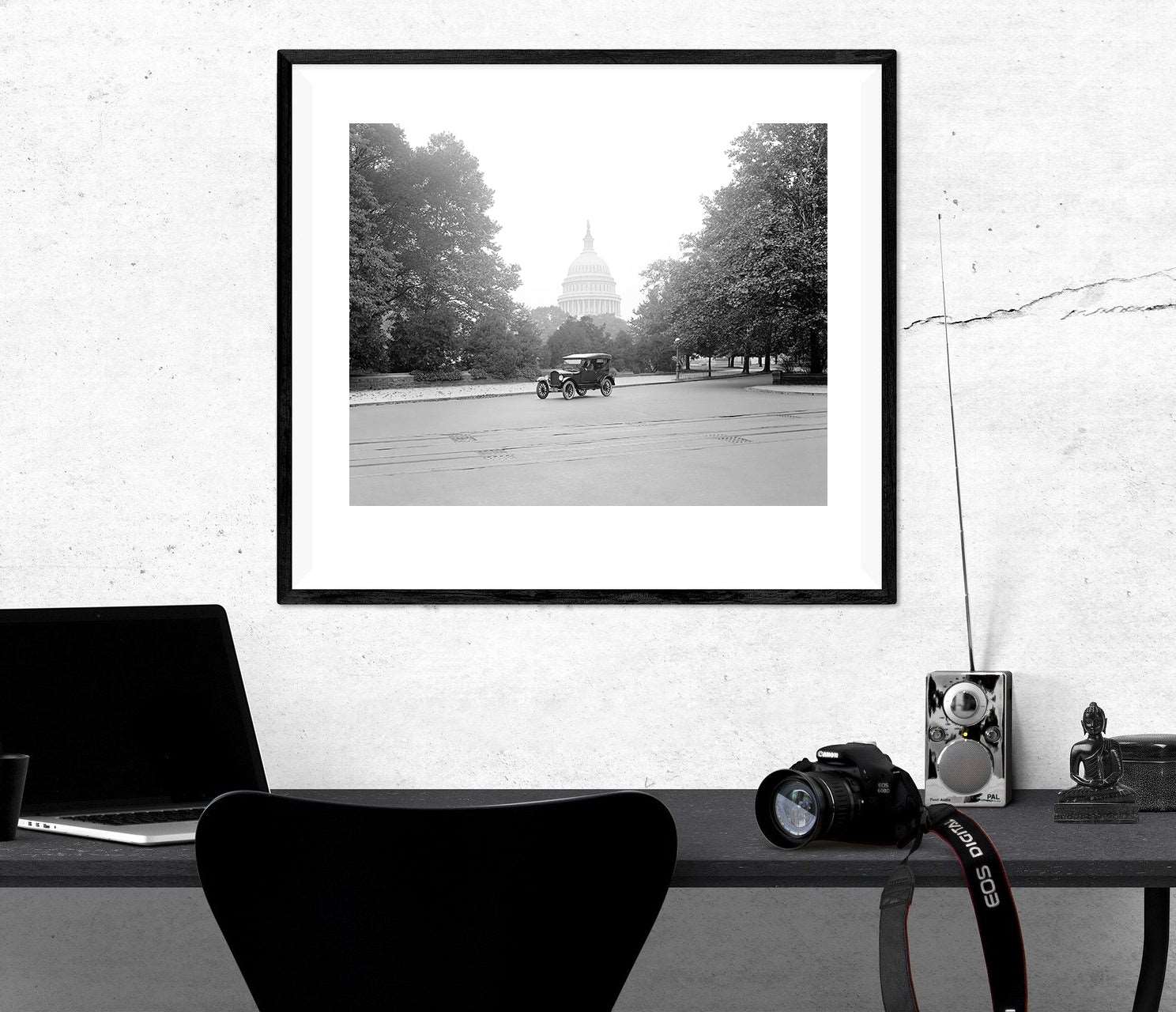 A framed paper print of a vintage photograph of a Ford Touring Car in Washington DC hanging above a desk