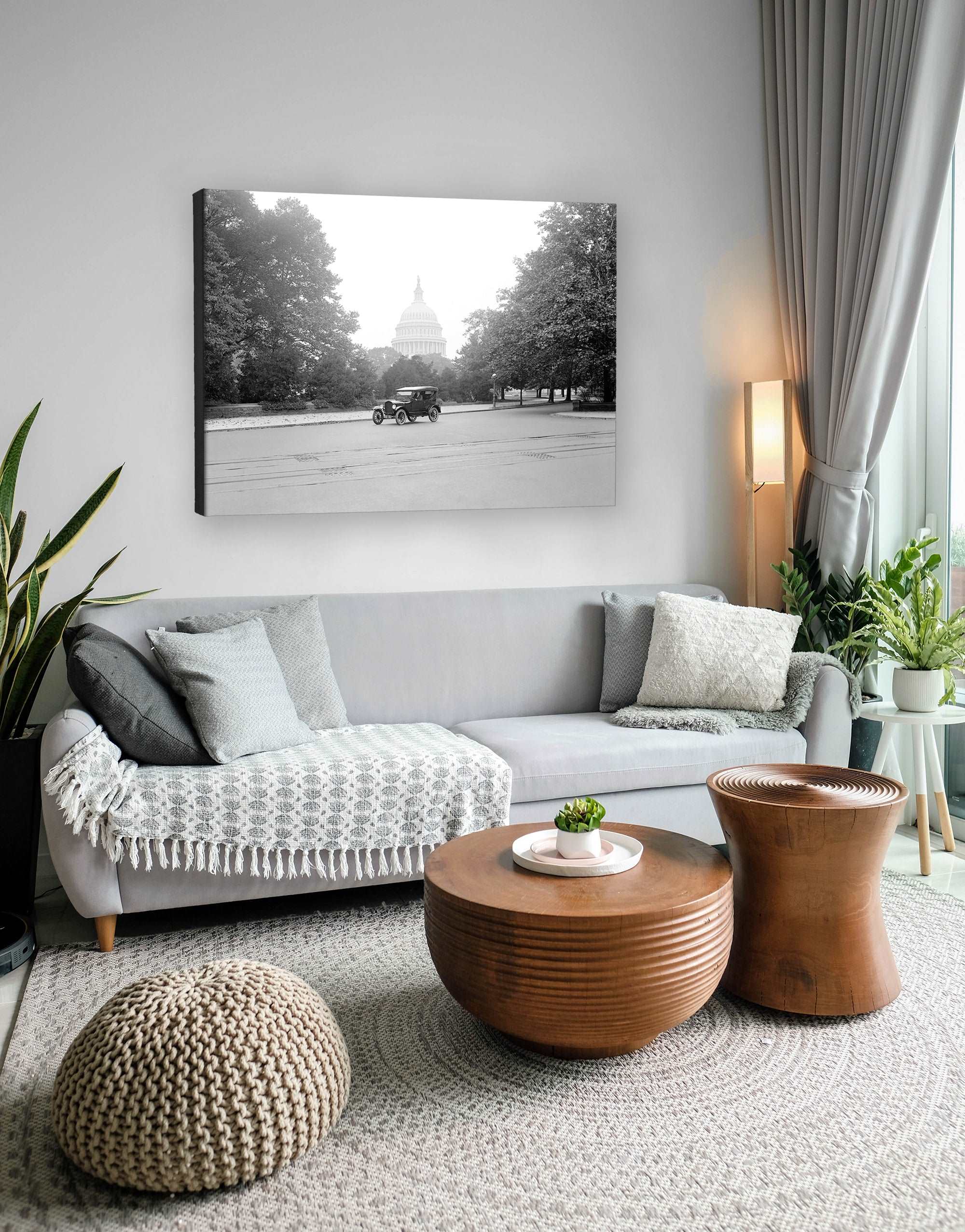 A living room with a canvas print above the couch featuring a vintage photograph of a Ford Touring Car