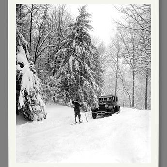 A mockup paper print of a vintage photograph of a Ford Motor Company vehicle in the snow