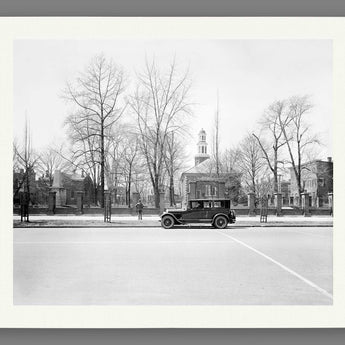 A paper print reproduction of vintage photography featuring a Ford outside Christ Church