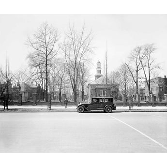 A vintage photograph of a Ford vehicle parked in front of Christ Church in Alexandria, Virginia
