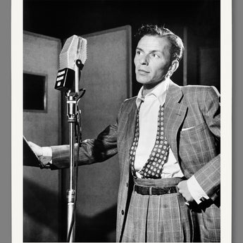 A mockup of a paper print reproduction of a vintage photo of Frank Sinatra in front of a microphone
