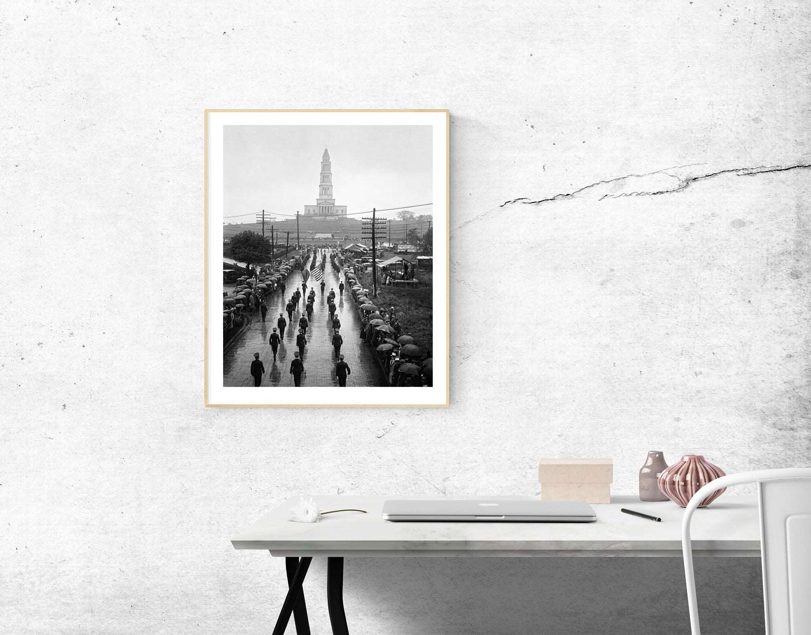 A framed paper print of a vintage photograph of the Masonic National Memorial hanging above a desk