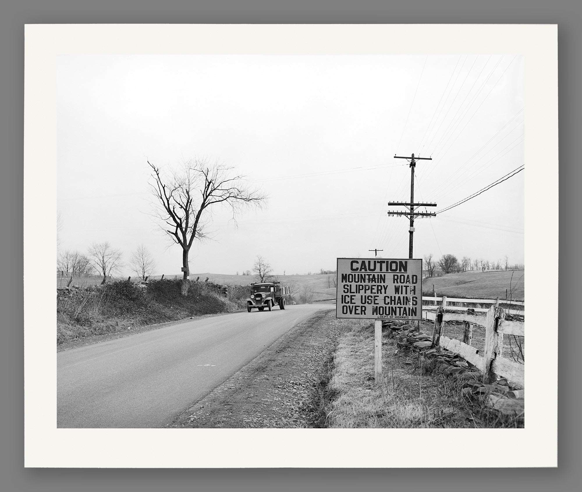 A paper print reproduction of a vintage photo of a car driving on US 50 in Virginia