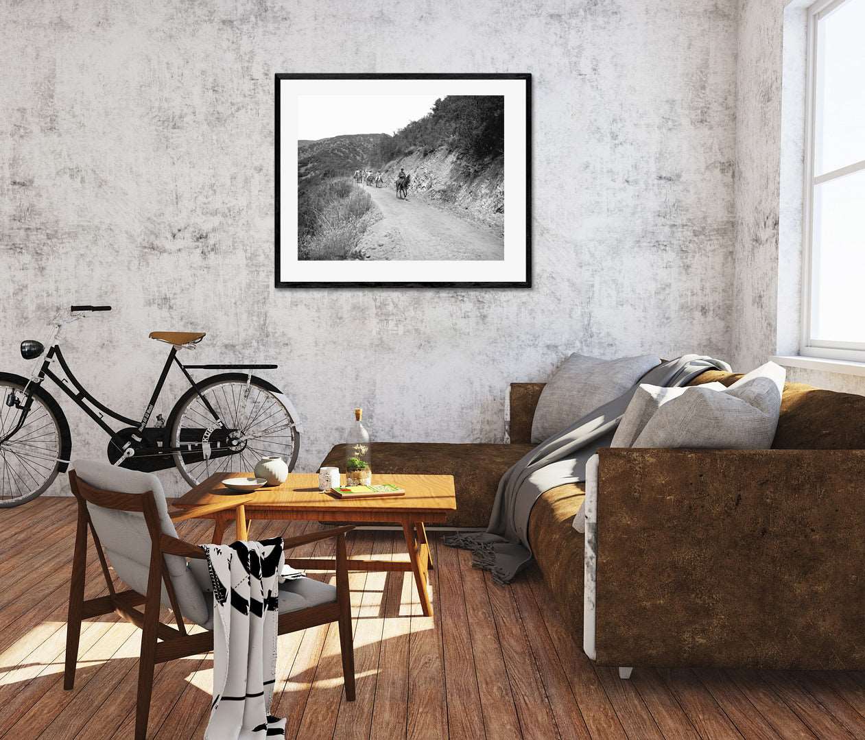 A living room with a framed print on the wall, featuring a vintage photograph of a group on horseback
