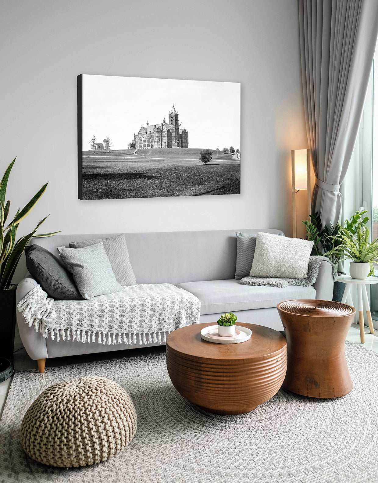 A living room with a canvas print on the wall, featuring vintage photography of Syracuse University