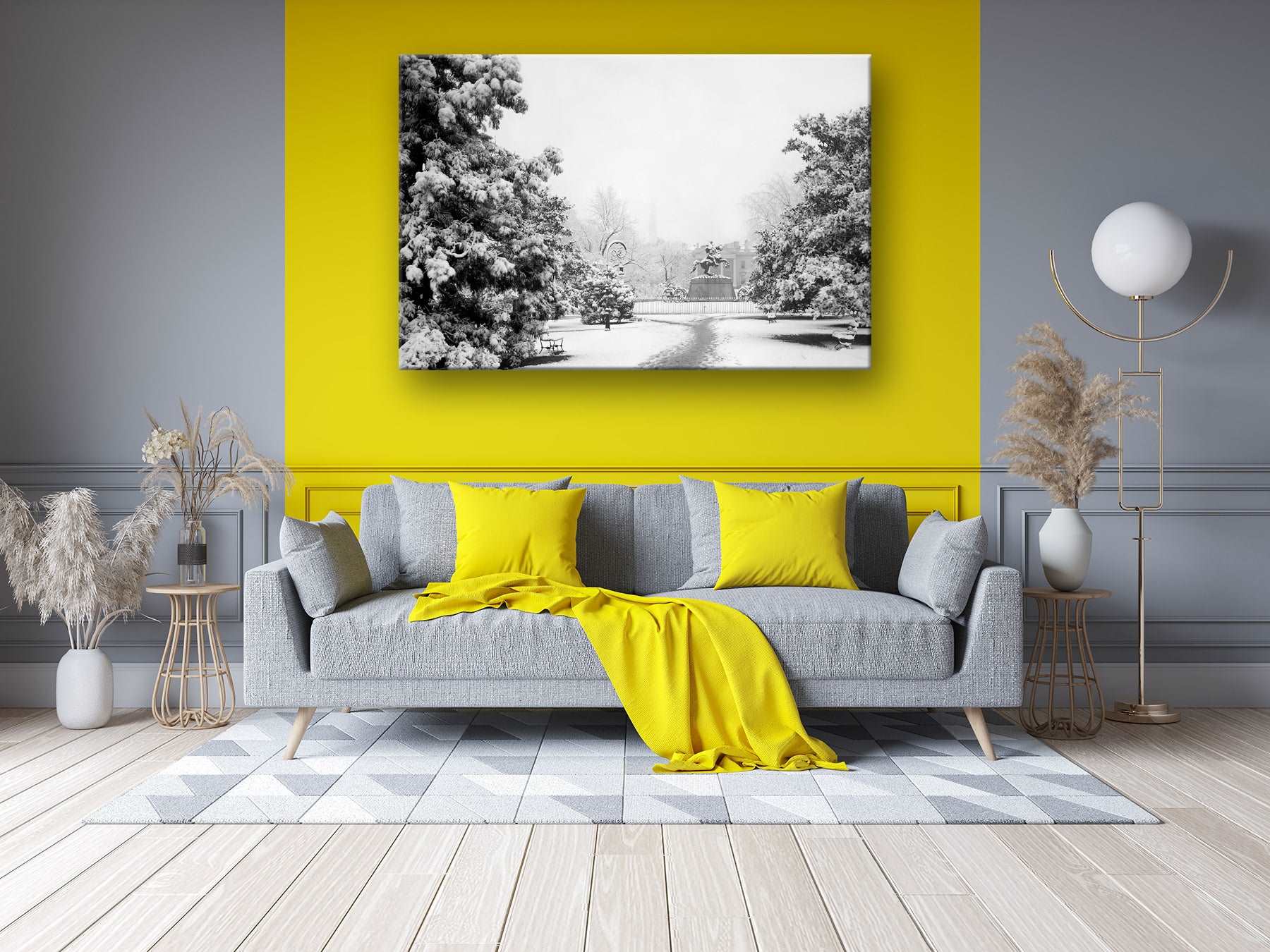 A photograph of a living room with a bright yellow wall and a canvas print of a vintage photograph of Lafayette Park
