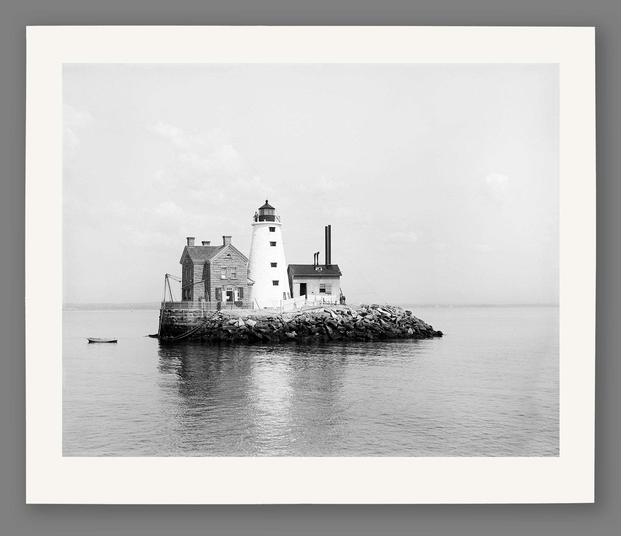 A fine art paper print of a vintage photograph of an island with a lighthouse