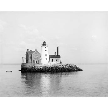 A vintage, black and white photograph of a Lighthouse on an island