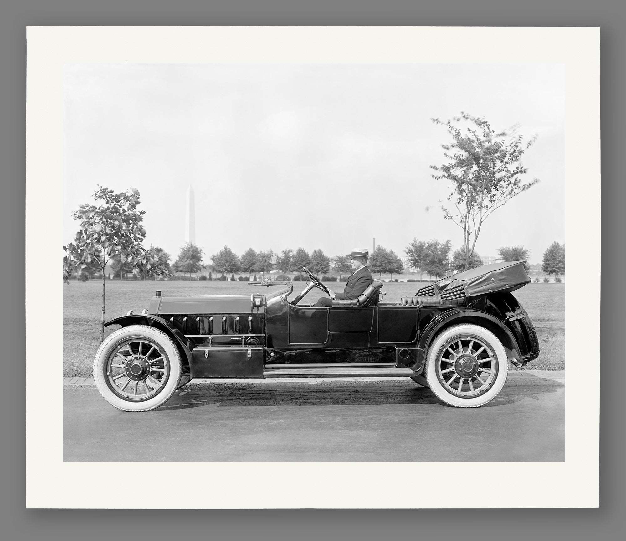 A paper print of a vintage photograph of a man in a vehicle by Marmon Motor Car Company