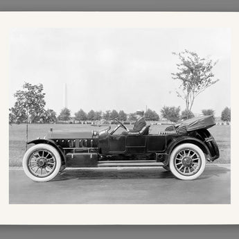 A paper print of a vintage photograph of a man in a vehicle by Marmon Motor Car Company