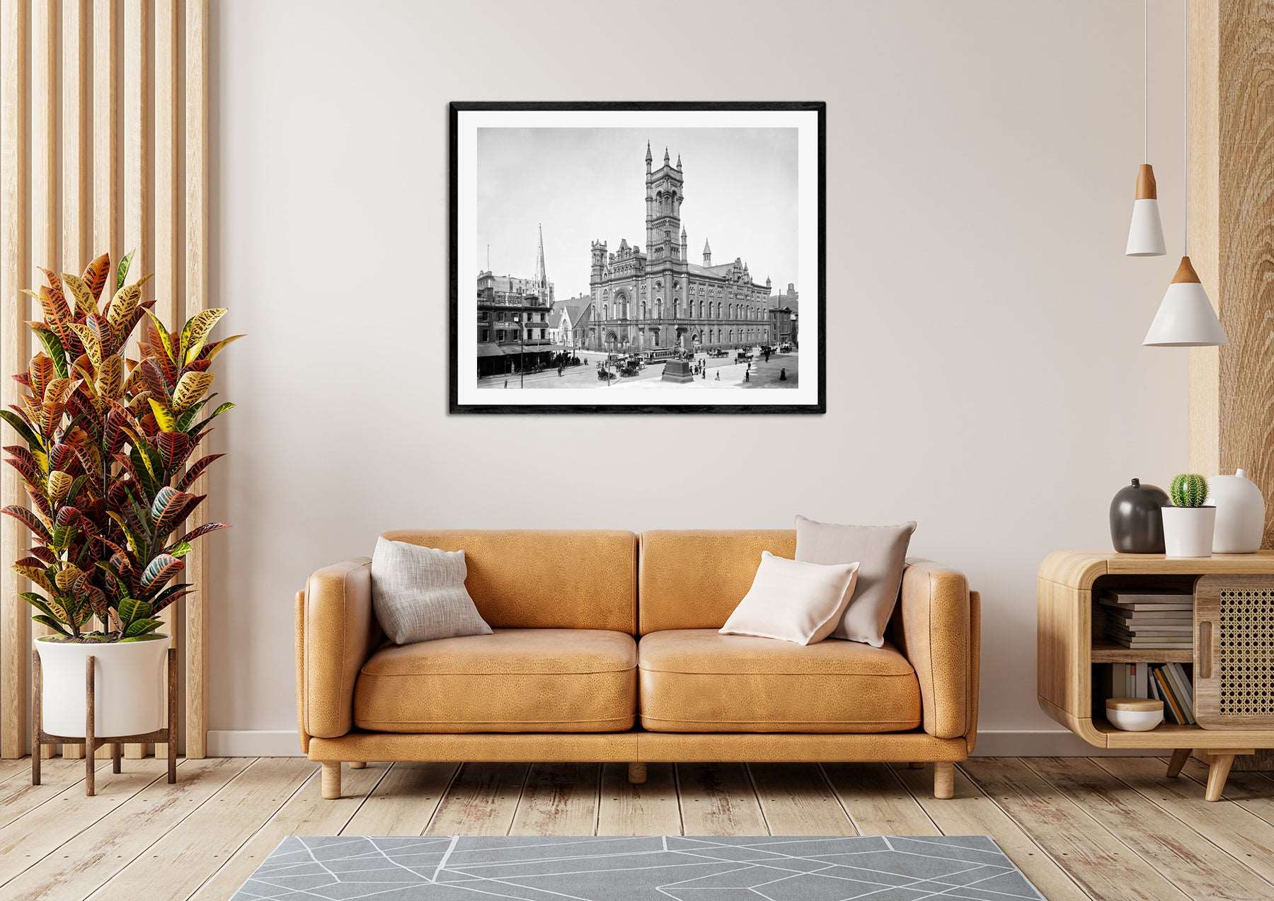 A framed print reproction of a vintage Philadelphia photograph hanging above a yellow couch