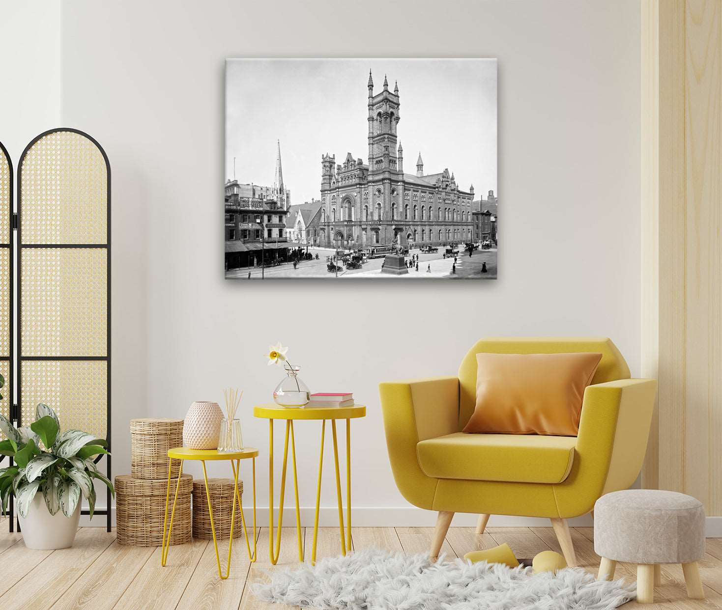 A bright room with yellow furniture and a canvas print on the wall, featuring a photo of Philadelphia's Masonic Temple