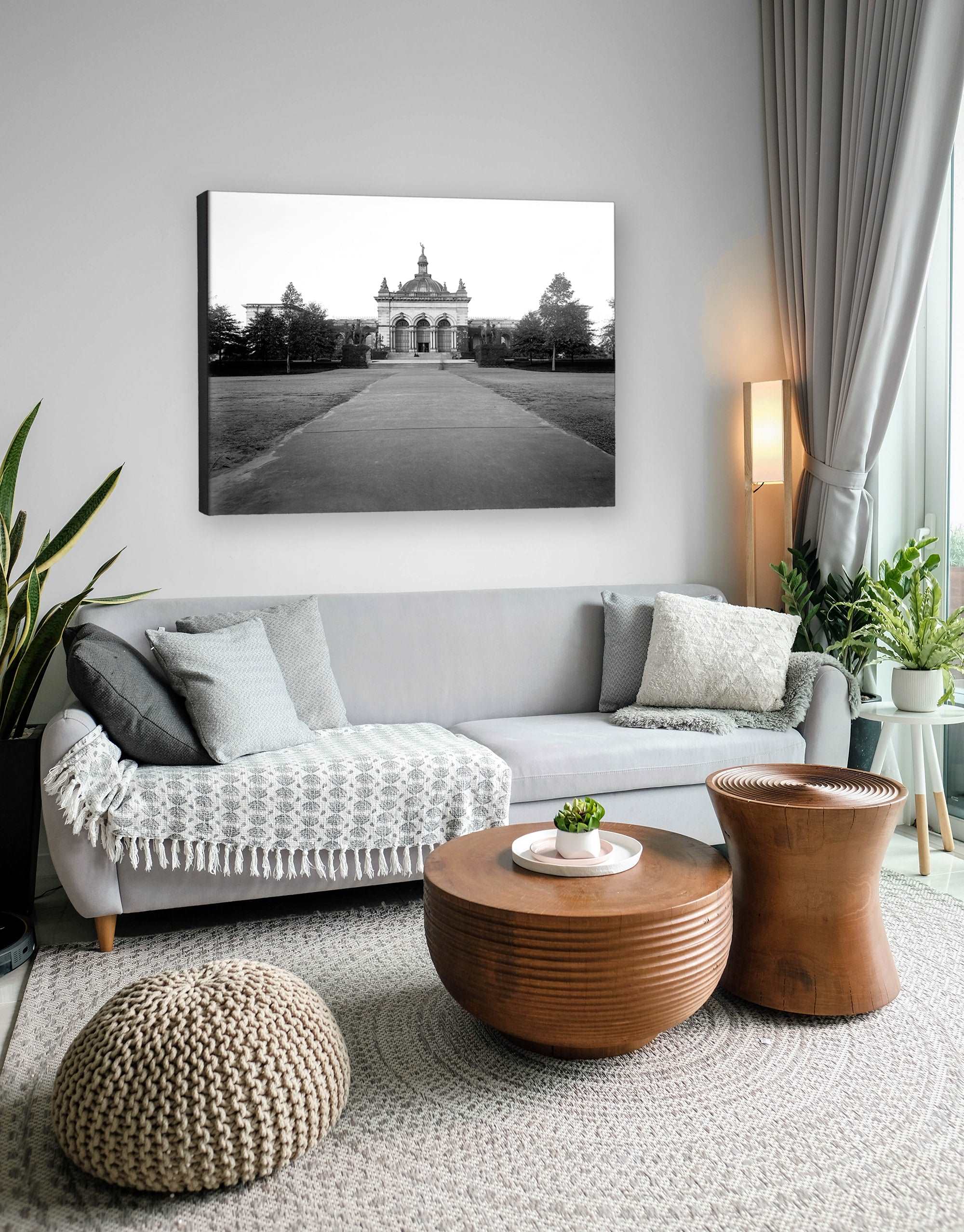 A photo of a living room with a canvas print of Memorial Hall in Fairmount Park hanging above the couch