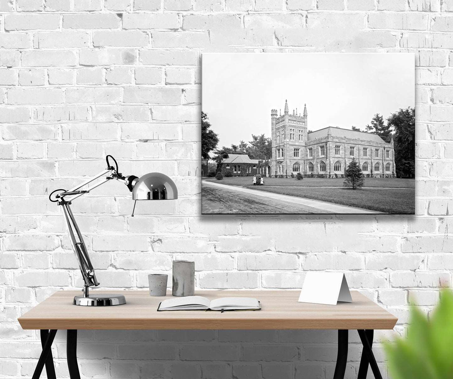 A canvas print hanving on a brick office wall, featuring a photo of Murray Dodge Hall