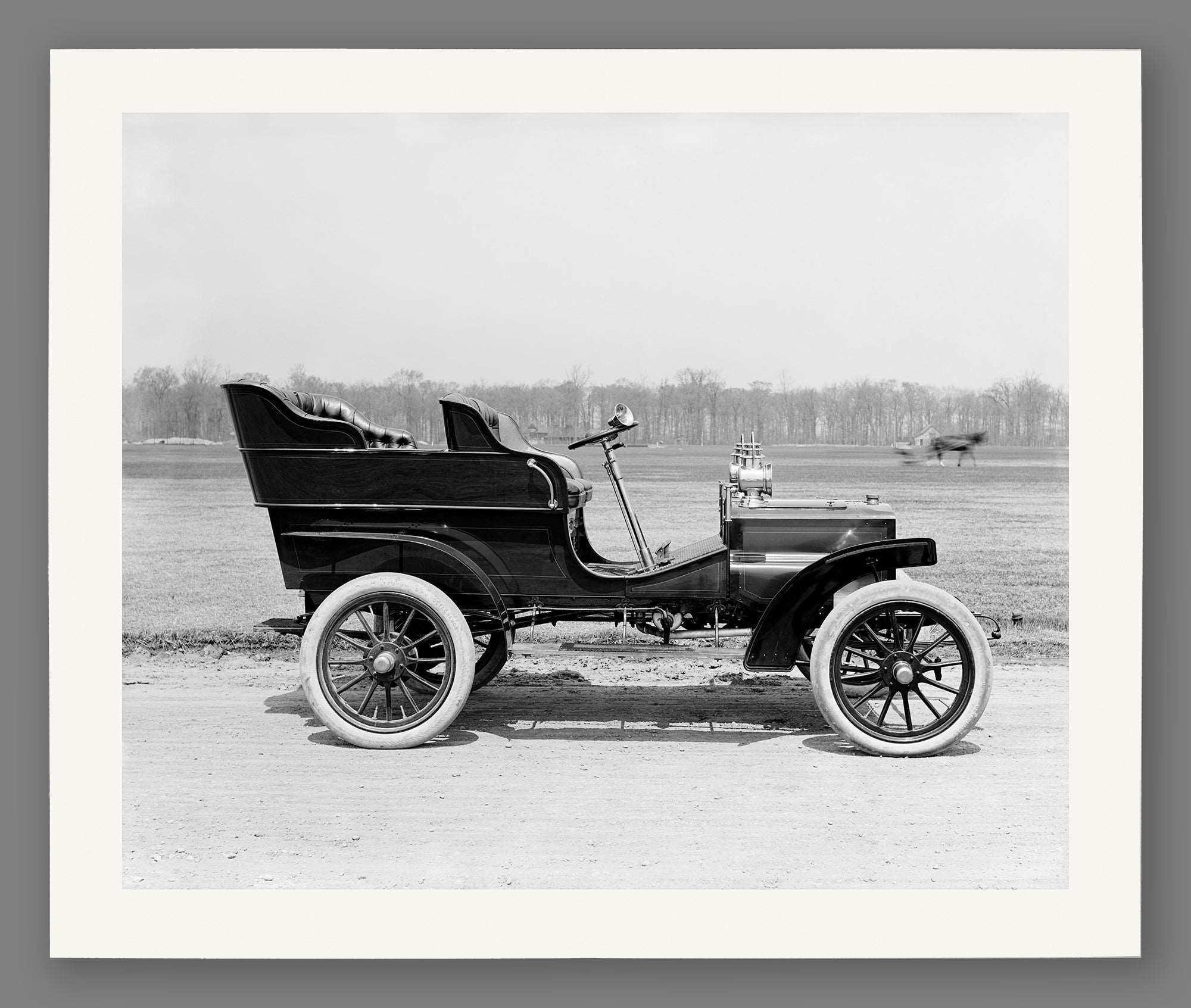 A fine art paper print of a vintage photograph of a vintage vehicle