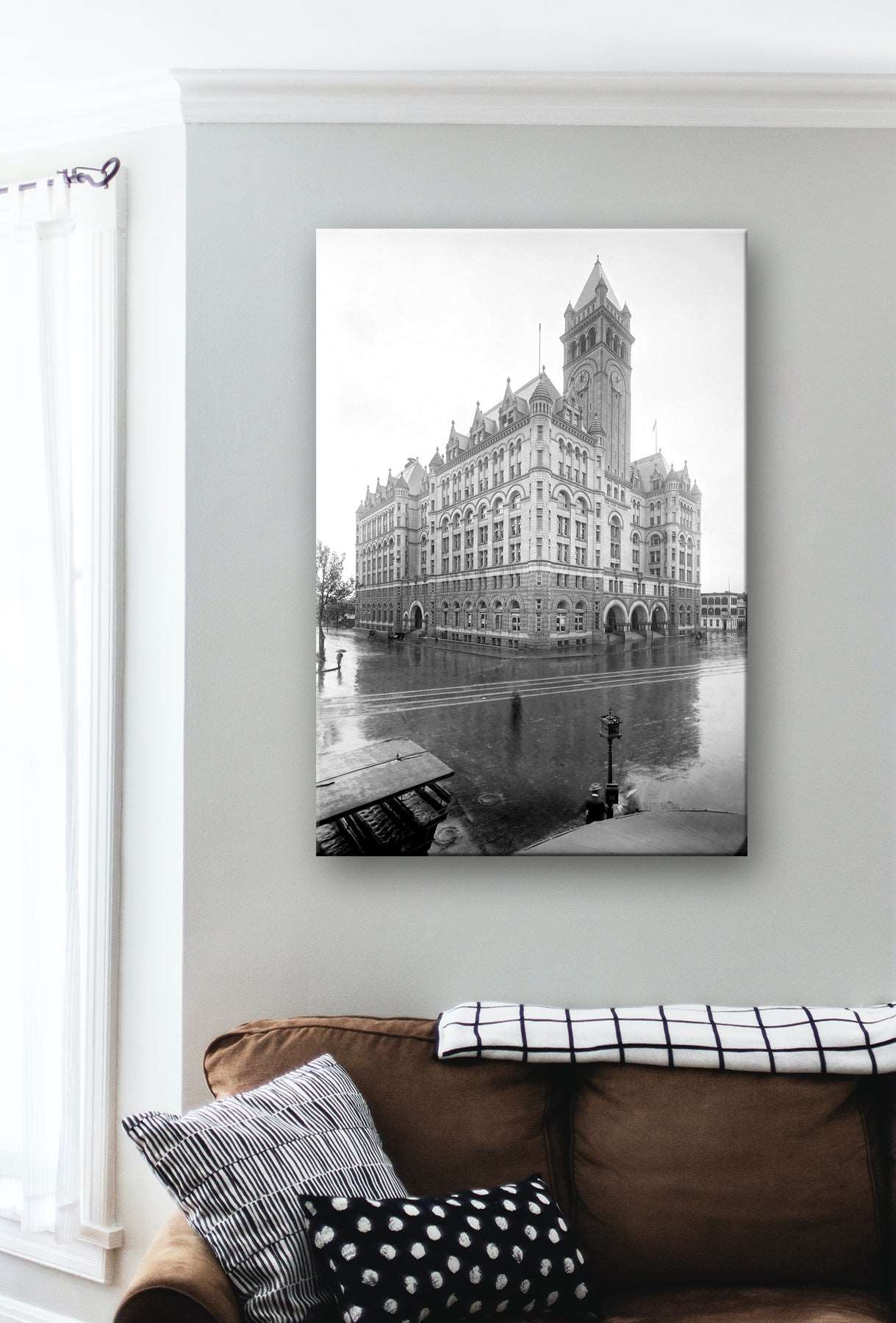 A living room with a canvas print on the wall, featuring a vintage photograph of the PO department in Washington DC