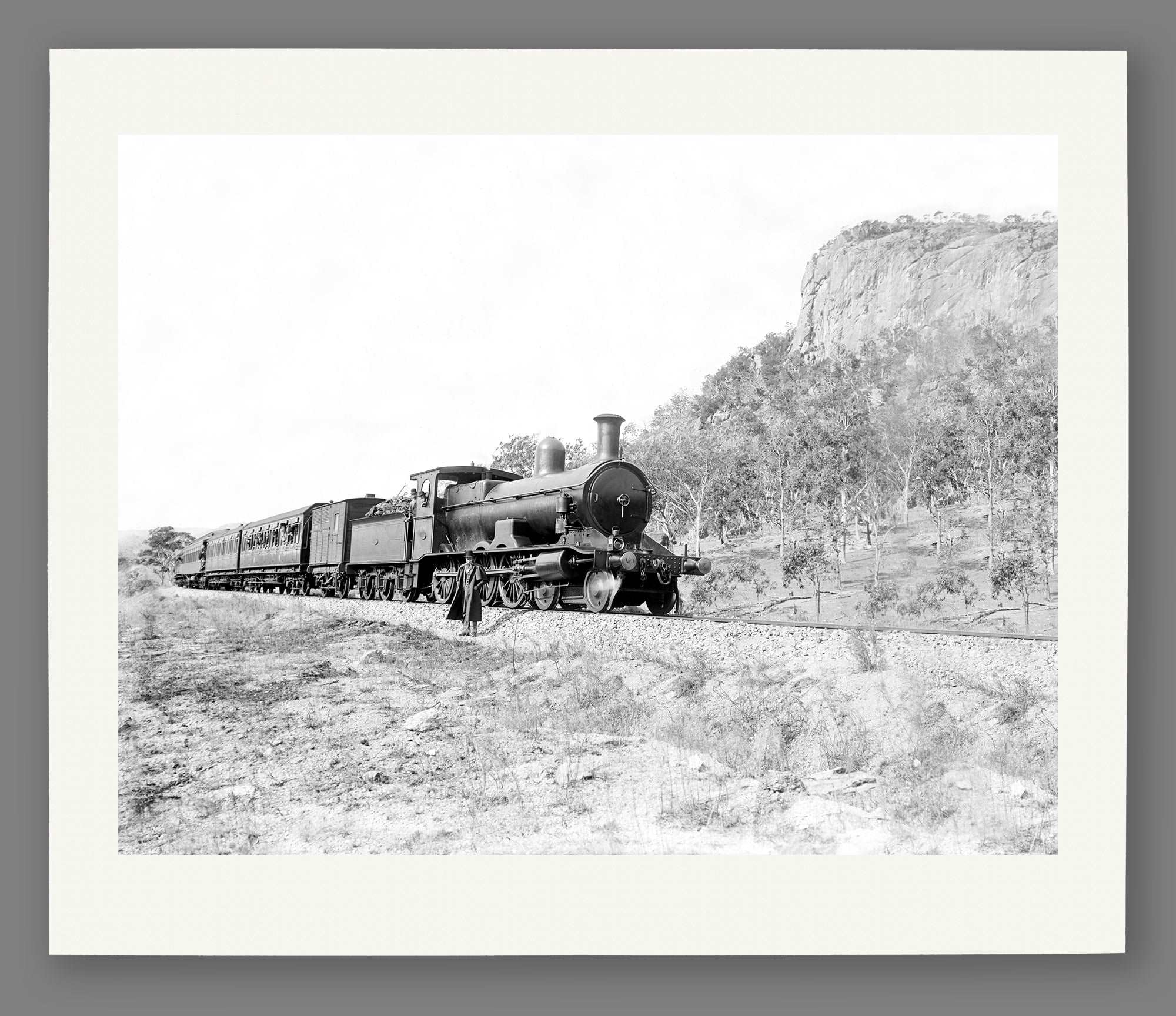 A fine art paper print of a vintage photograph of a passenger train