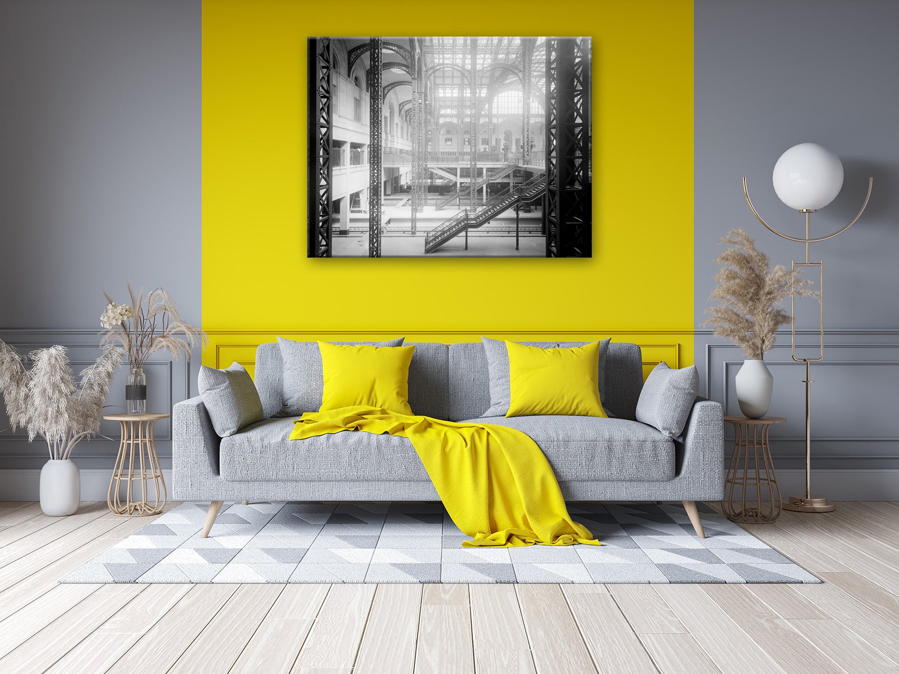 A canvas print of a vintage photo of Penn Station hanging in a living room with a yellow wall