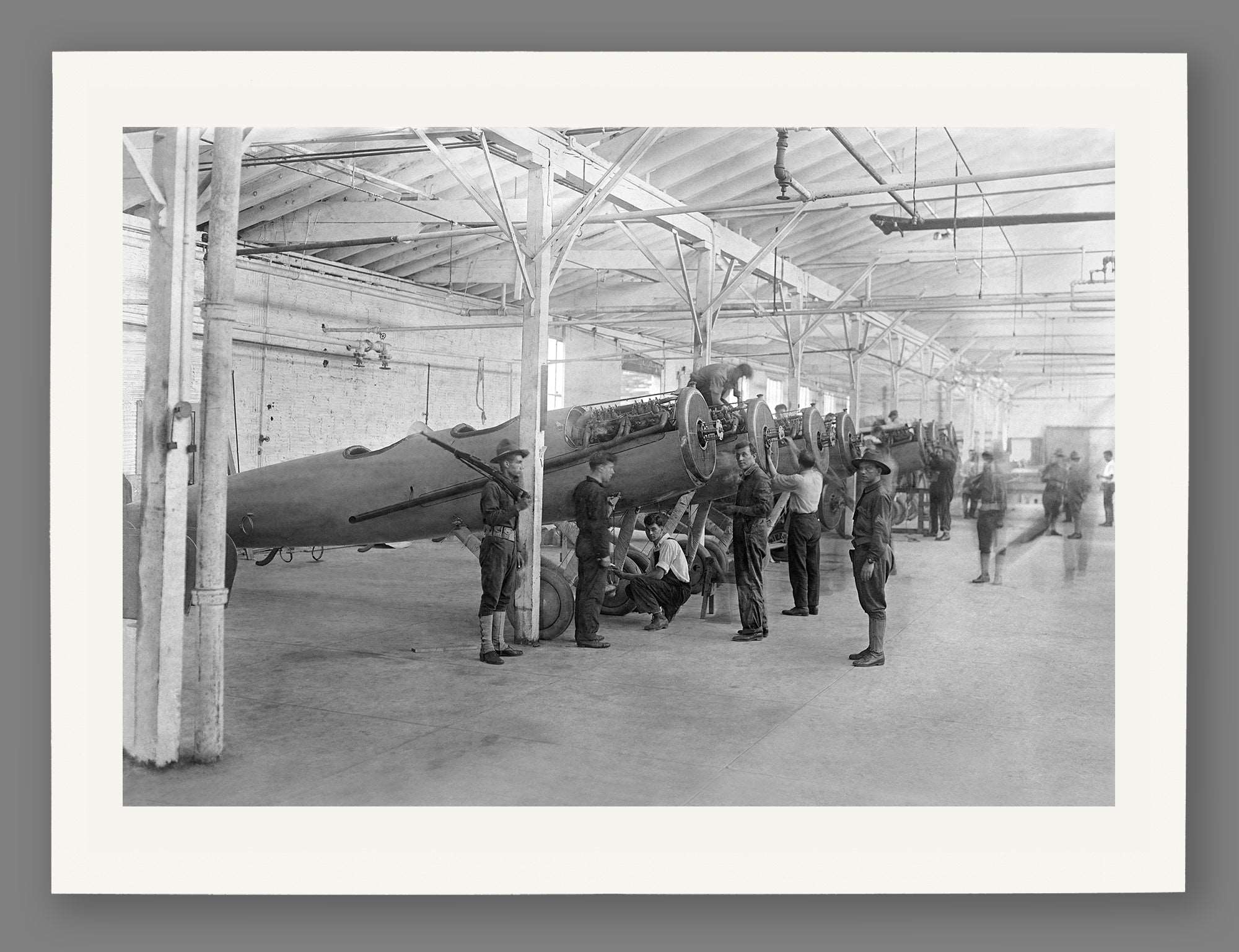 A paper print featuring vintage photography of a plane shop in College Point