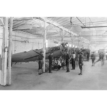 A vintage photograph depicting a group of men in a plane shop in College Point