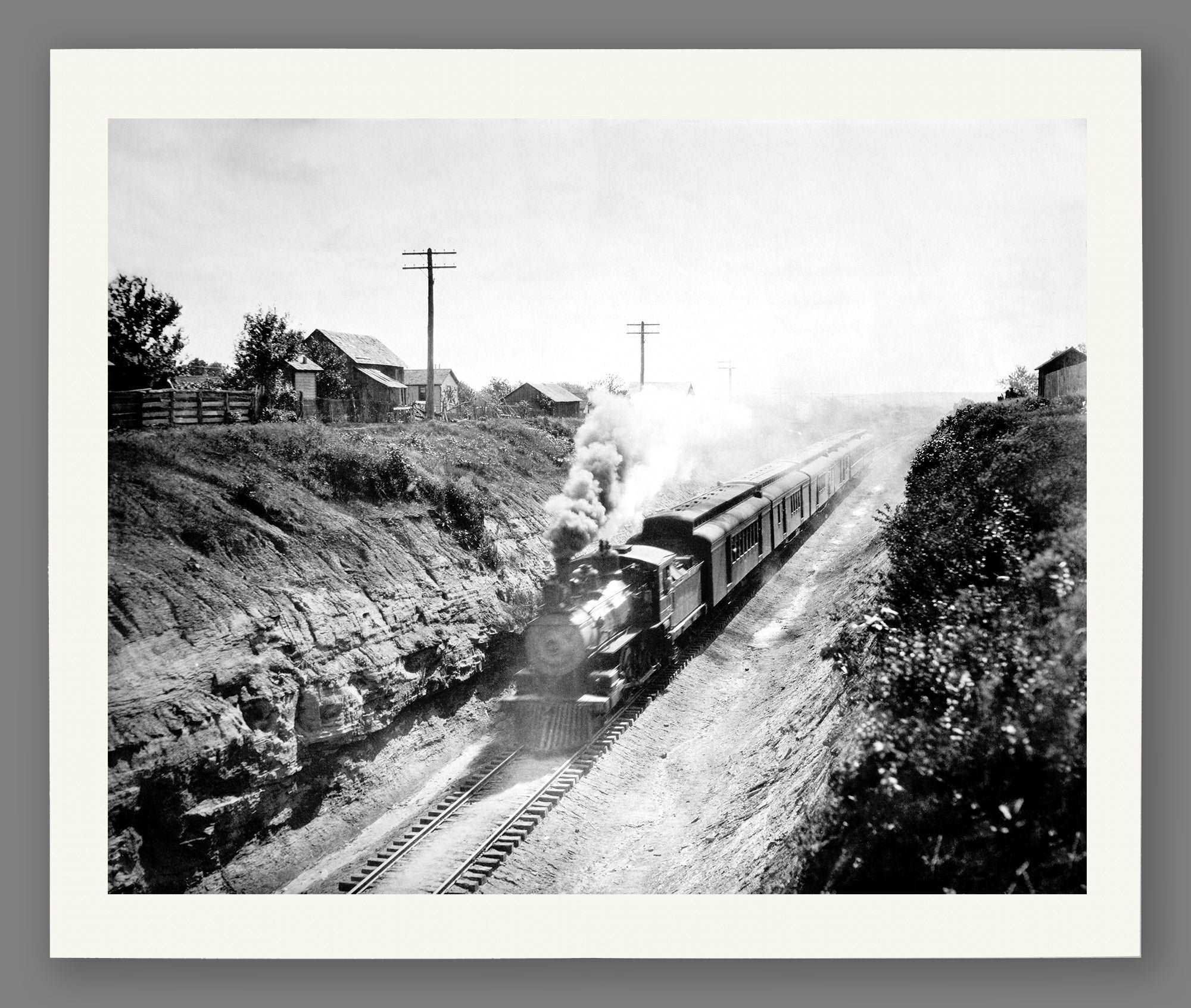 An archival paper print of a vintage photograph of a railroad train