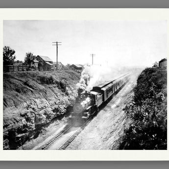 An archival paper print of a vintage photograph of a railroad train